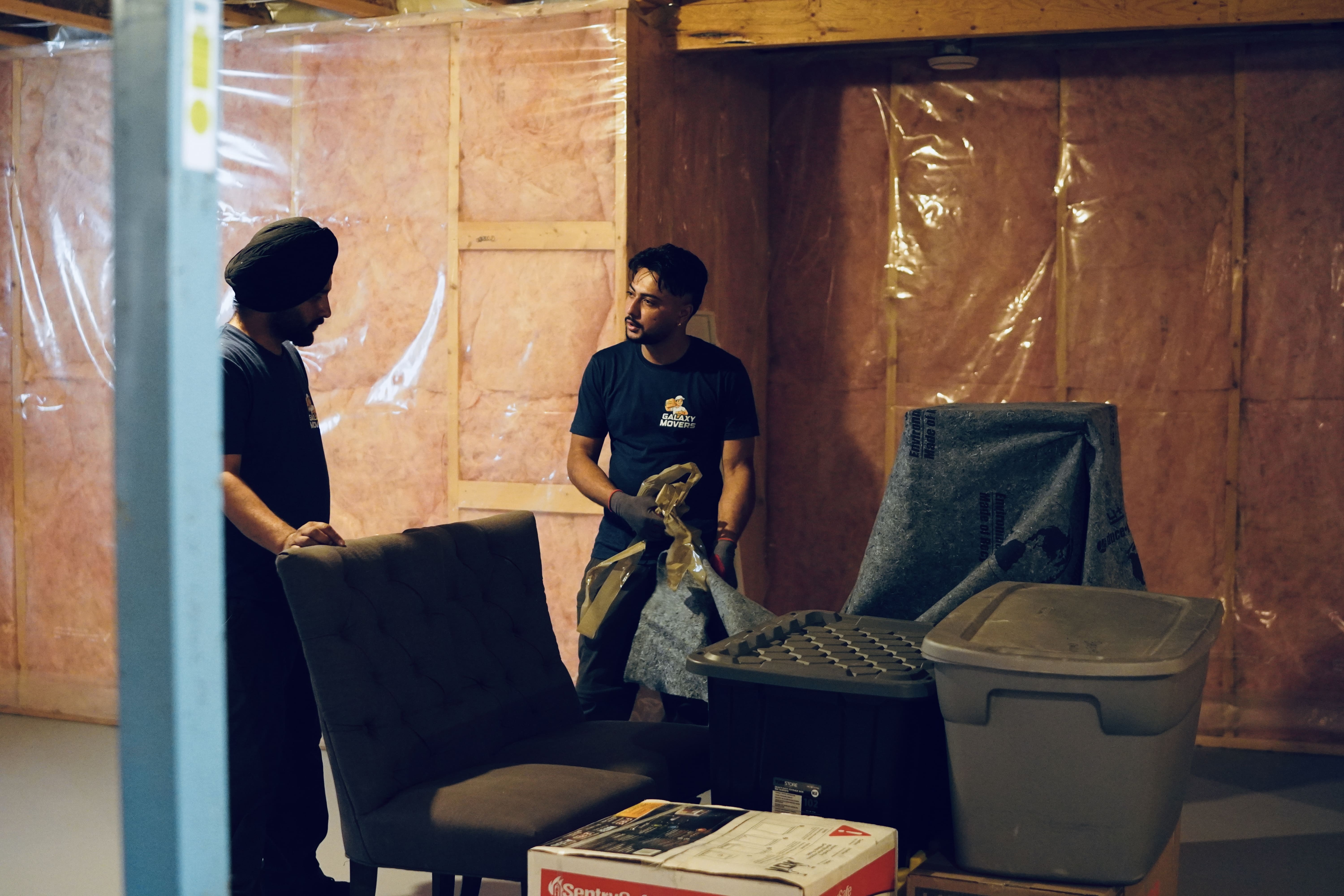 Professional movers wrapping and preparing furniture for Calgary house moving